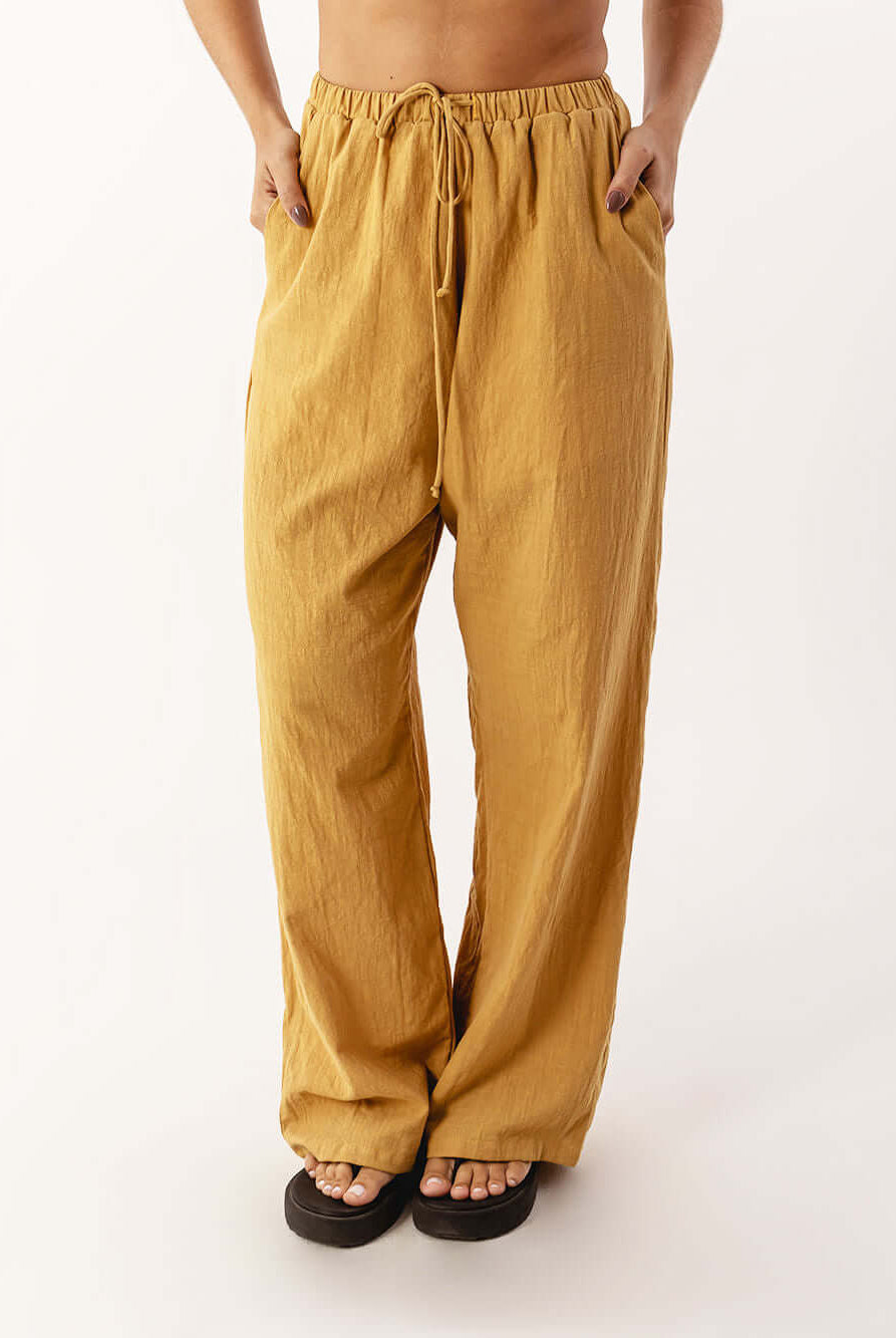 Calça Nat da Greenish em caqui, confortável e moderna, com cós elástico e bolsos, ideal para o dia a dia.