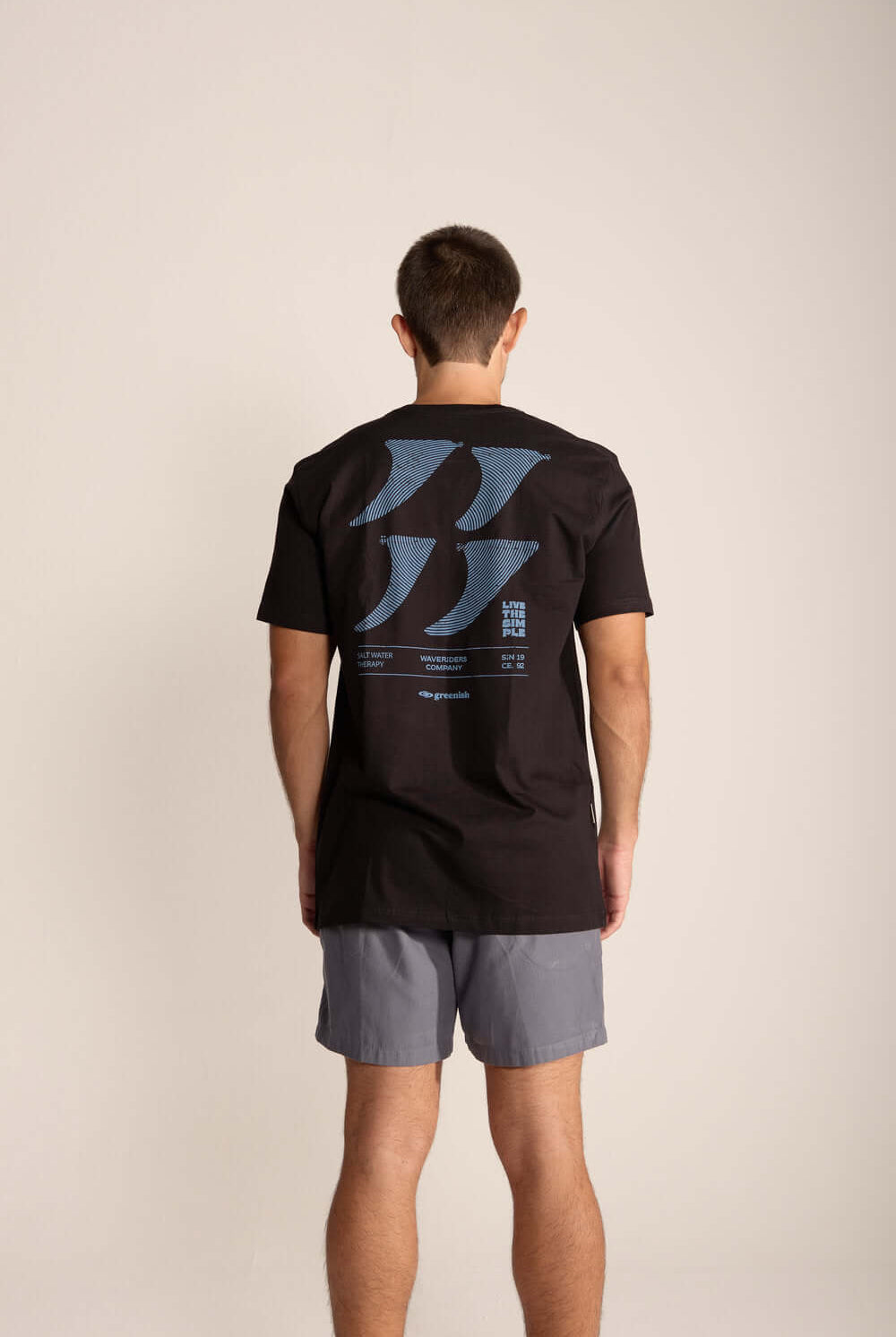 Camiseta da Greenish Live The Simple, estampa exclusiva nas costas, usado por homem com shorts.