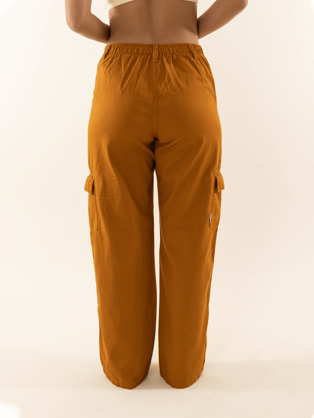 Calça cargo sarja Gio caramelo da Greenish, com cintura alta e bolsos laterais, vista traseira.
