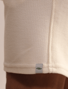 Bermuda Moletom Aspem Natural Greenish, mínima e confortável em malha macia, ideal para estilo casual pós-praia e dia a dia.