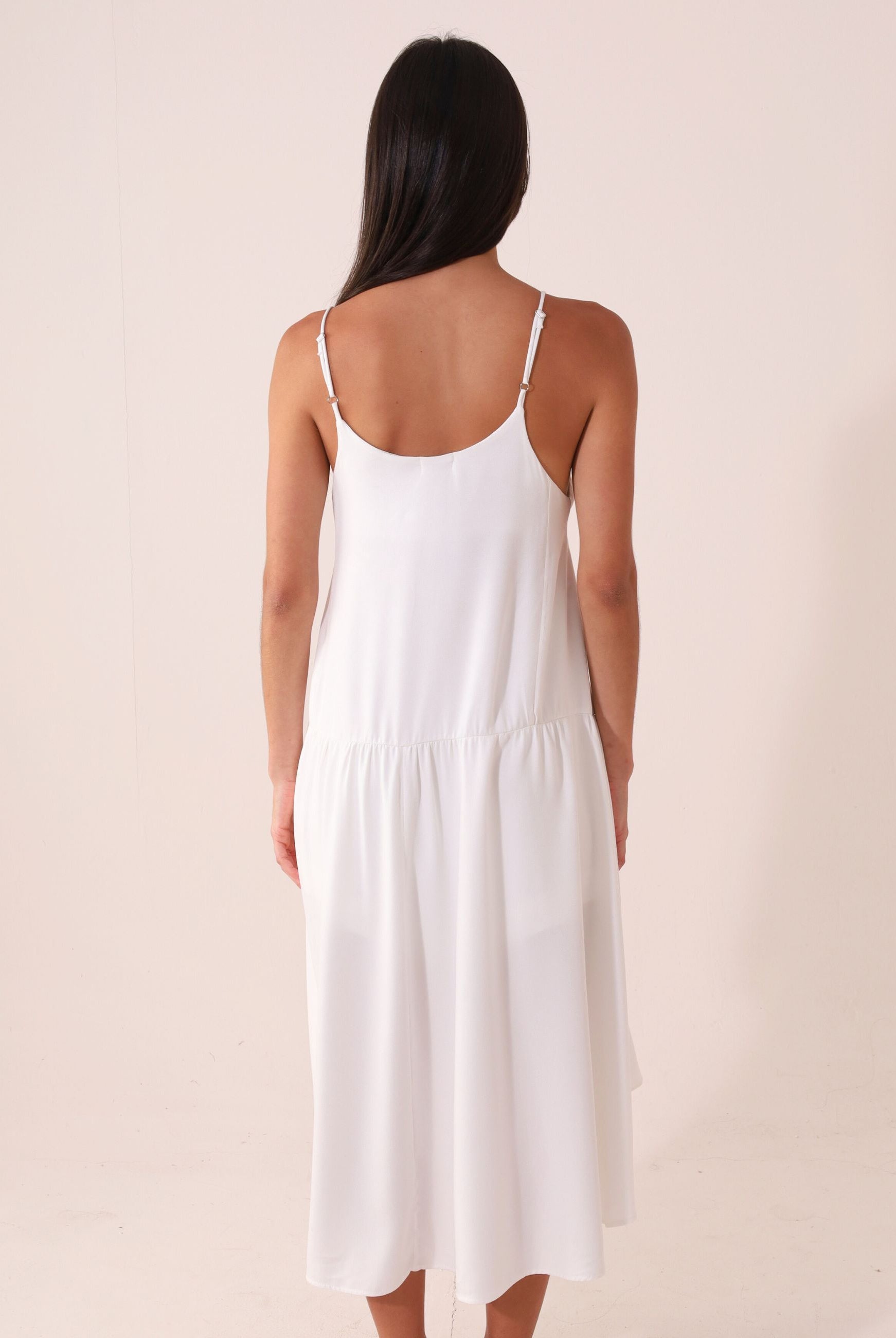 Mulher vestindo Blusa Áurea - Off White da marca Greenish, com modelagem fluida e alças finas ajustáveis. Ideal para dias de sol.