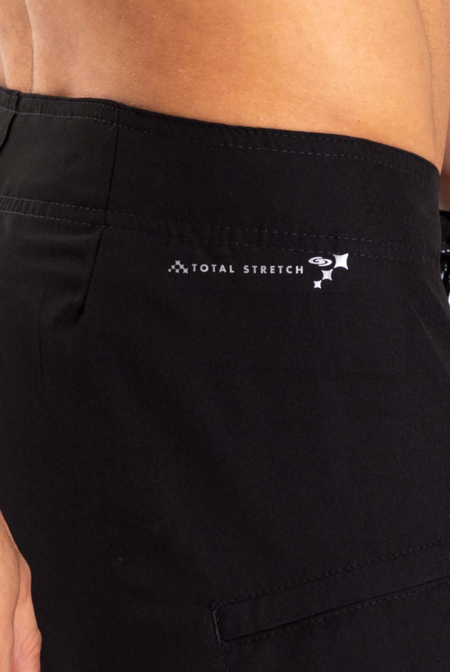 Detail of Greenish Total Stretch Boardsport shorts showcasing logo and side pocket for enhanced performance.