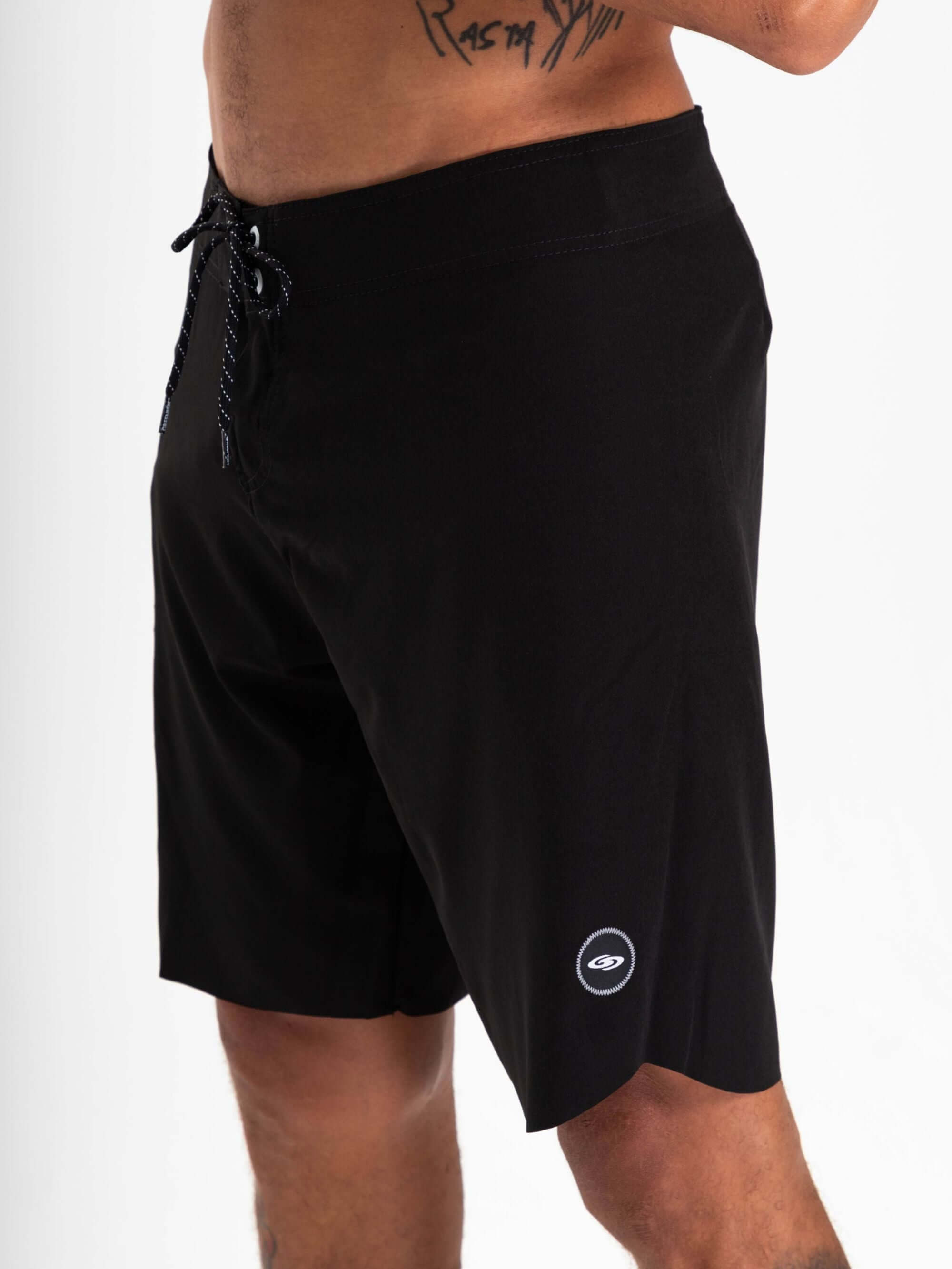 Greenish Ultralight Basic boardshort in black, designed for high performance and ultimate comfort in aquatic sports.
