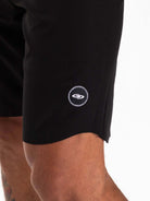 Close-up of the Greenish Ultralight Basic boardshort in black, showcasing the brand logo and premium fabric details.