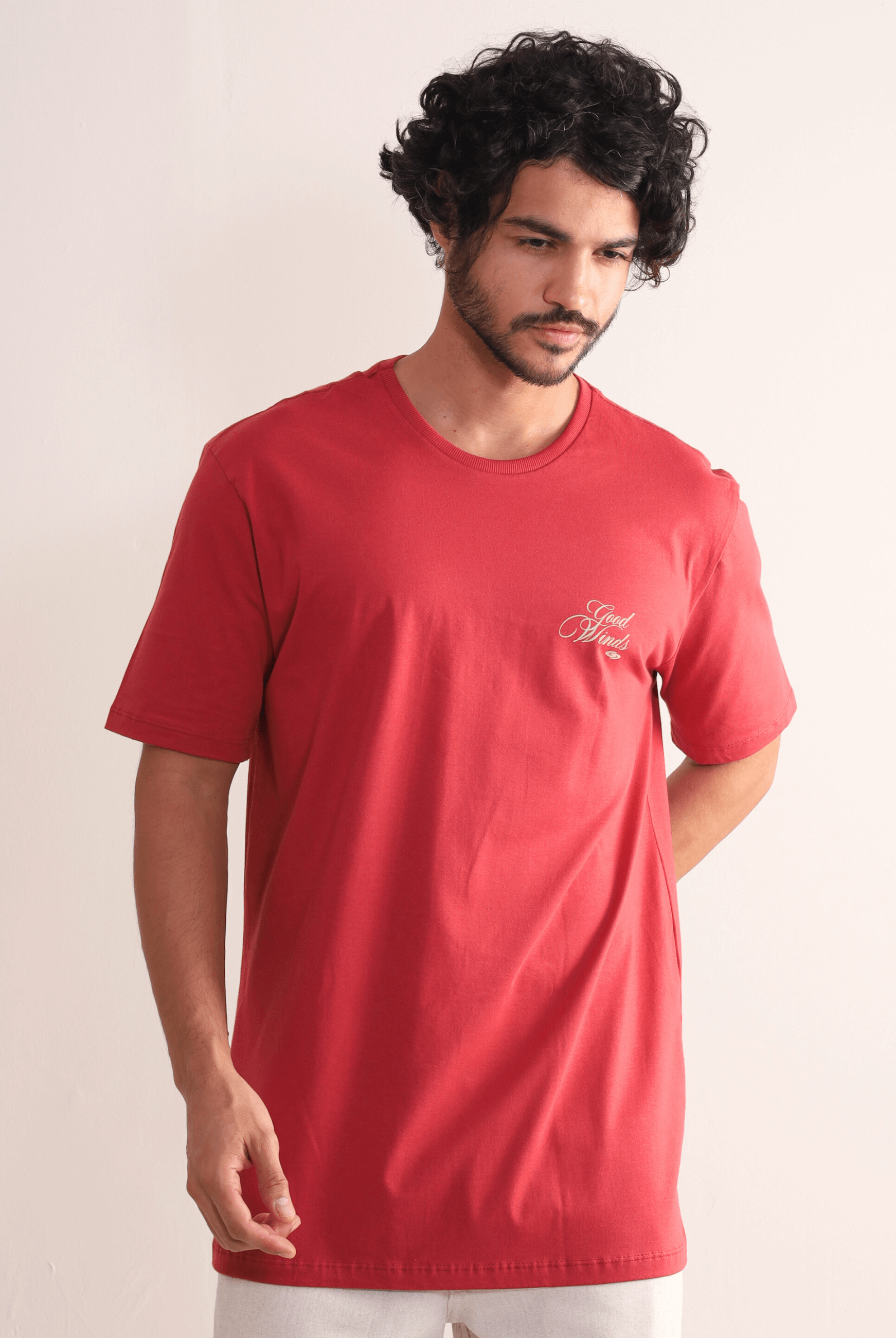 Homem vestindo Camiseta Kites & Good Winds Vermelho da Greenish, modelo clássico em algodão com bordado frontal, ideal para conforto e estilo.