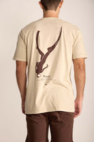 Camiseta Mergulhador da Greenish em cor areia, com estampa artística nas costas e modelagem clássica.