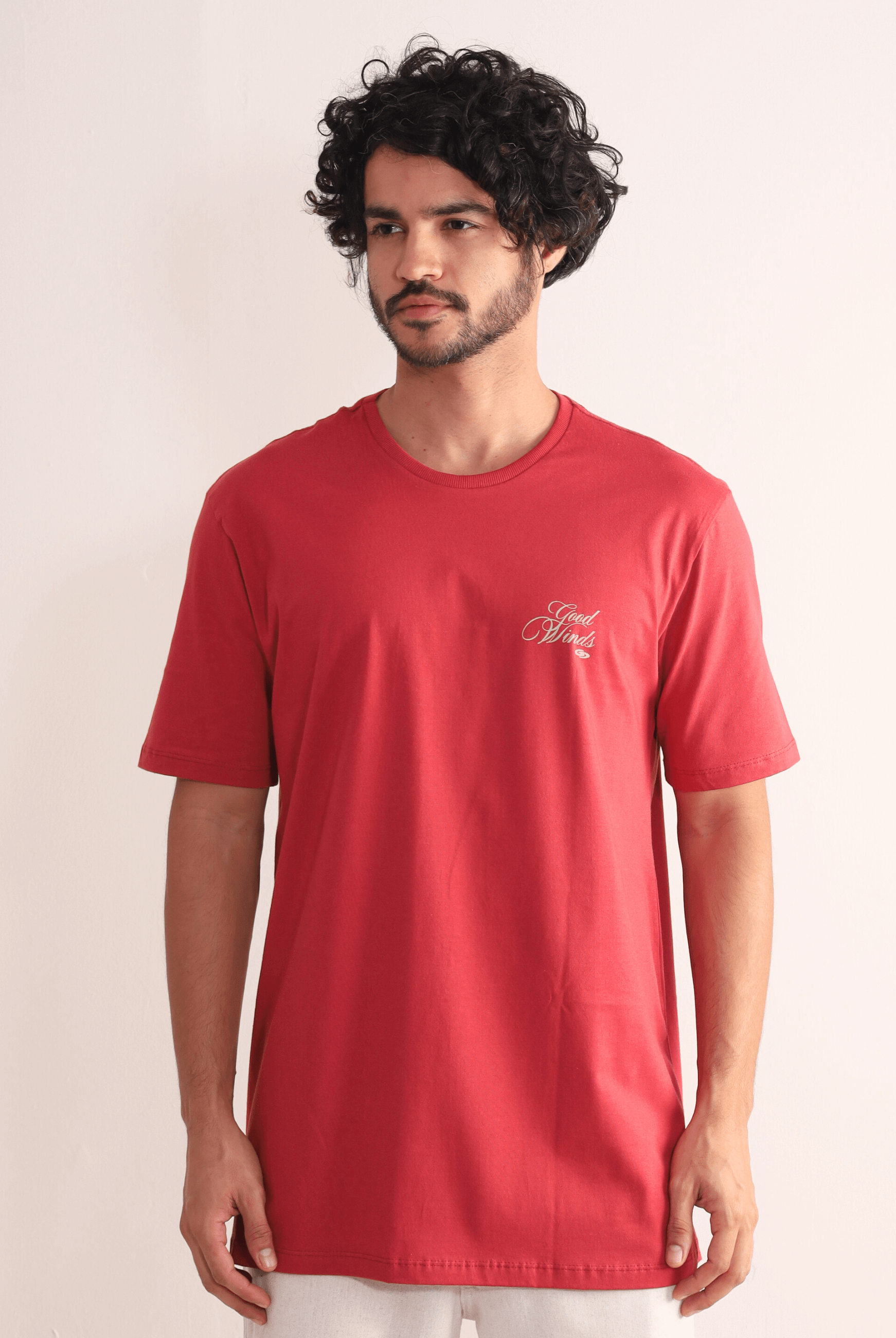 Homem vestindo Camiseta Kites & Good Winds vermelha da marca Greenish, com bordado frontal e toque macio de algodão.