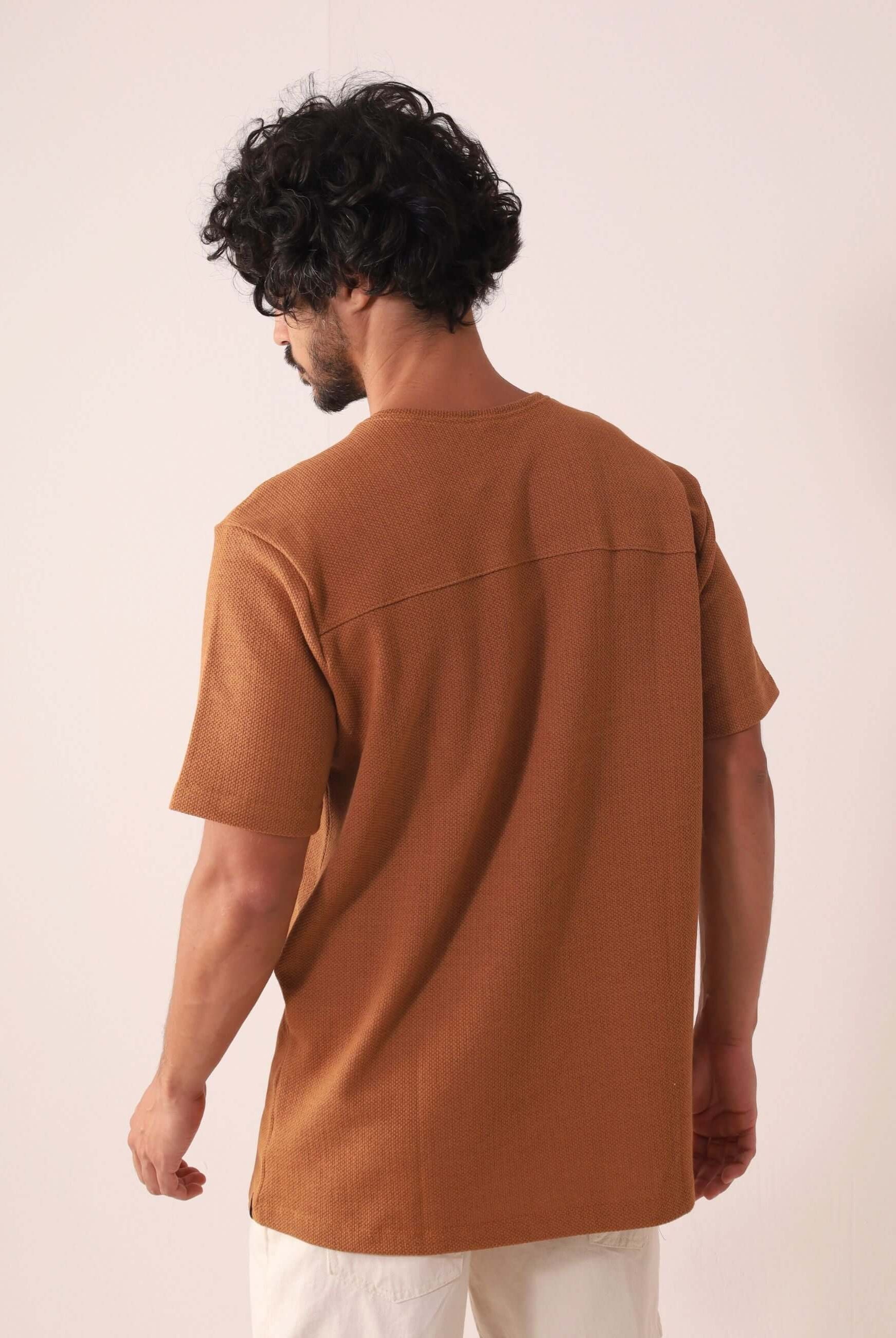 Homem vestindo a CAMISETA MARÉ - CAQUI Greenish, destacando caimento clássico e toque sofisticado. Elegância em algodão, poliéster e elastano.