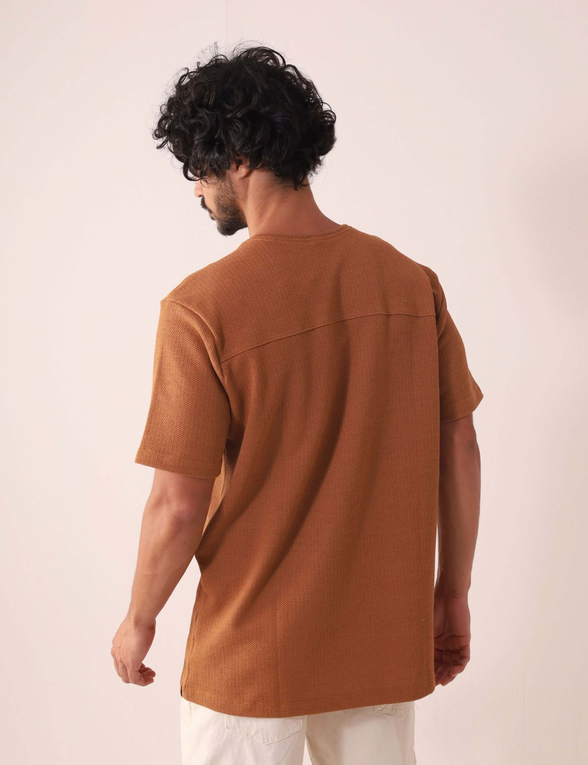 Homem vestindo a CAMISETA MARÉ - CAQUI Greenish, destacando caimento clássico e toque sofisticado. Elegância em algodão, poliéster e elastano.