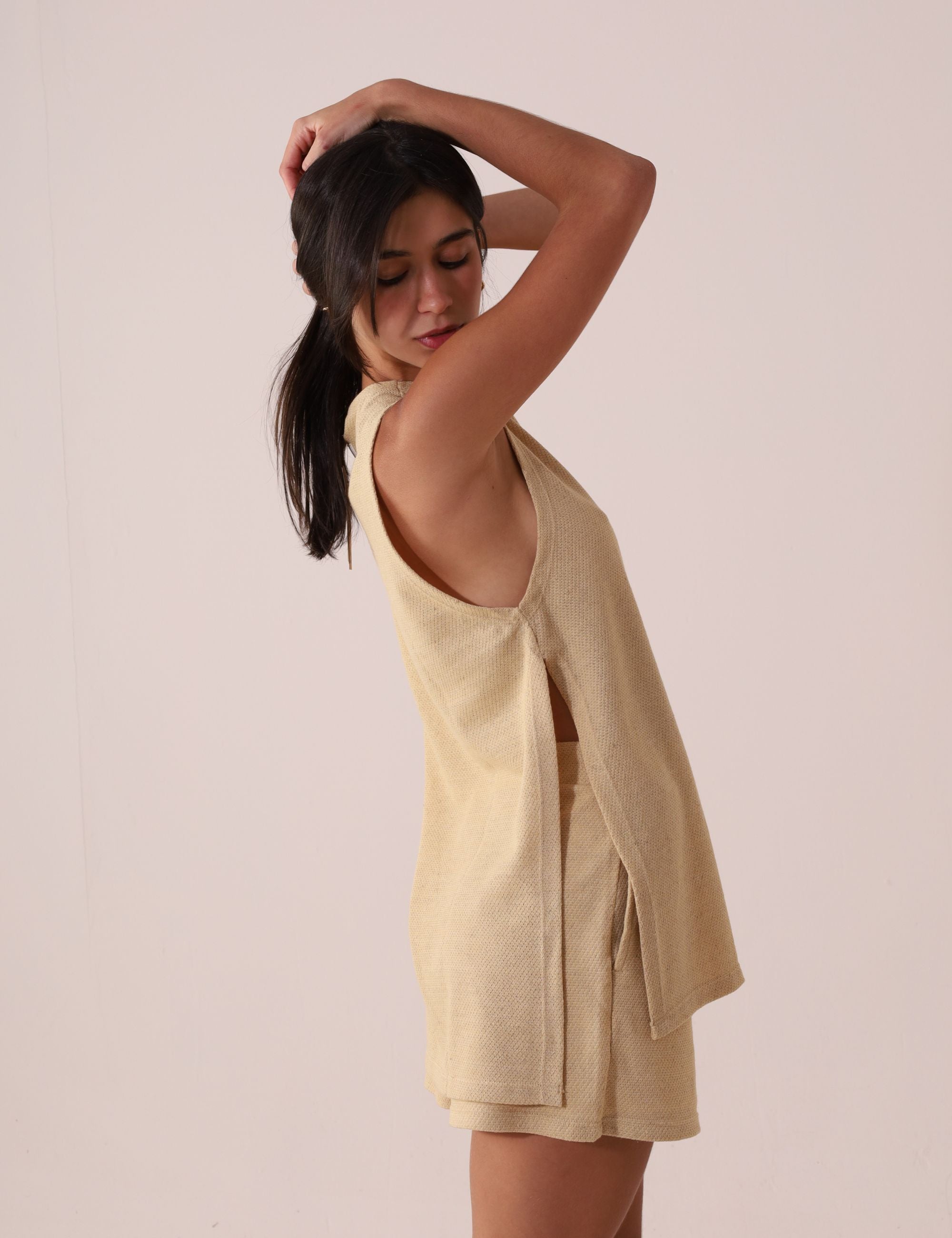 Modelo usando REGATA FUTURE - BEGE com shorts, estilo leve e natural da marca Greenish, ideal para dias quentes e looks casuais sofisticados.