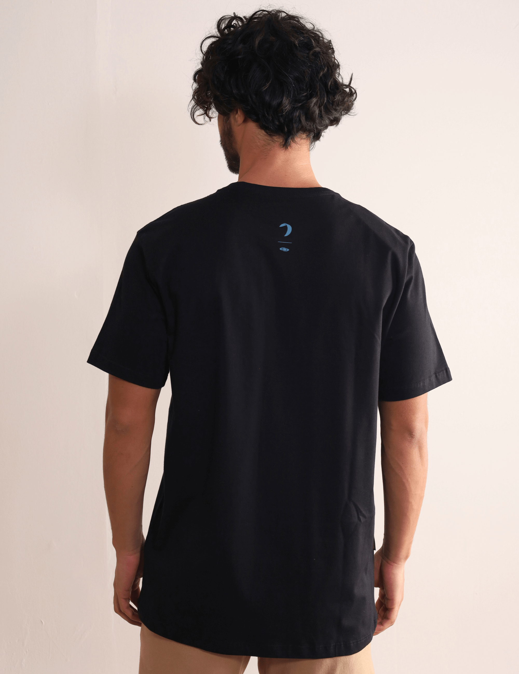 Homem vestindo a Camiseta Wind Is All I Need preta da Greenish, leve e confortável, com estampa nas costas, ideal para movimento.