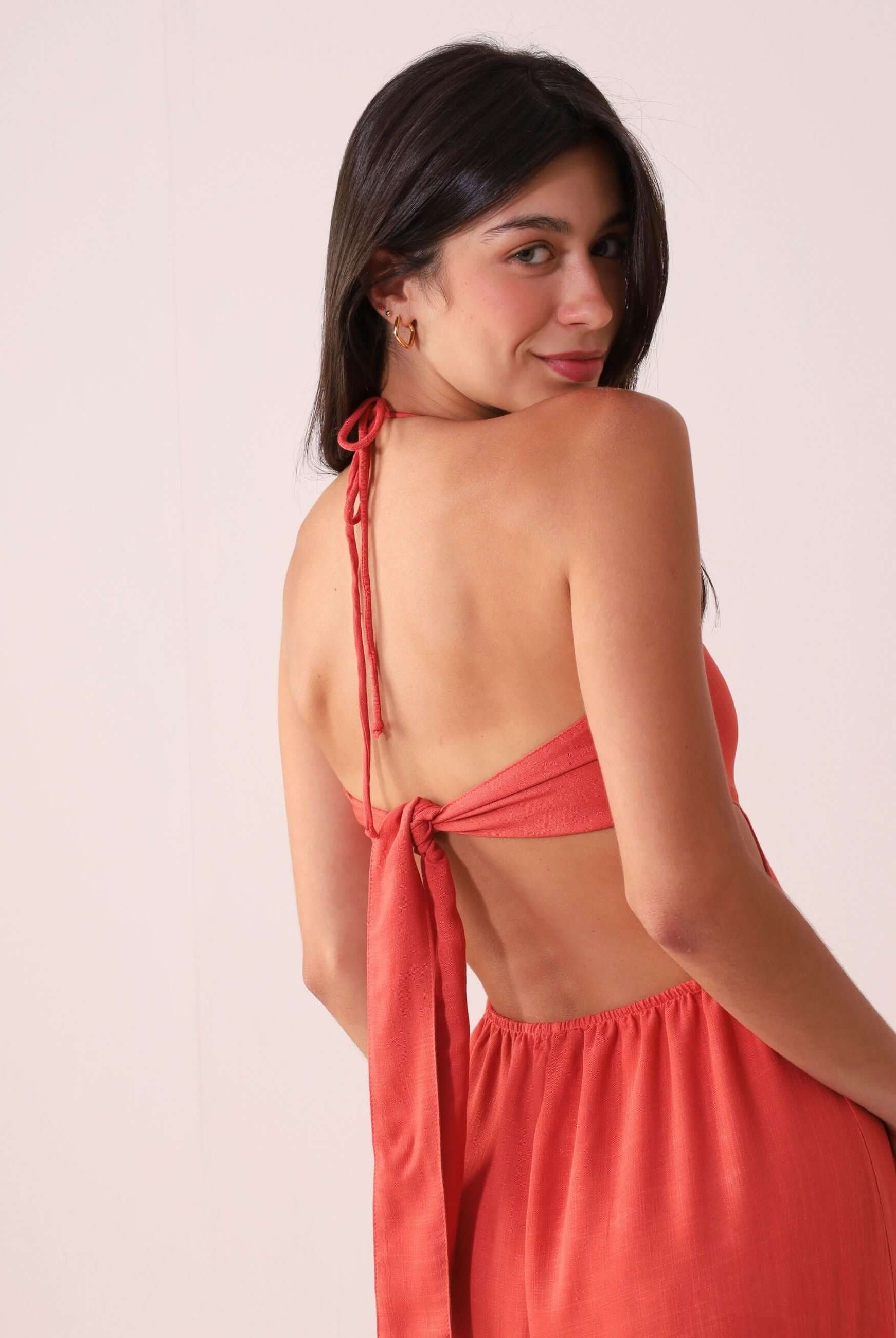 Woman wearing Macacão Rustic - Telha showing back tie detail, perfect for warm days with a light and flowy look.