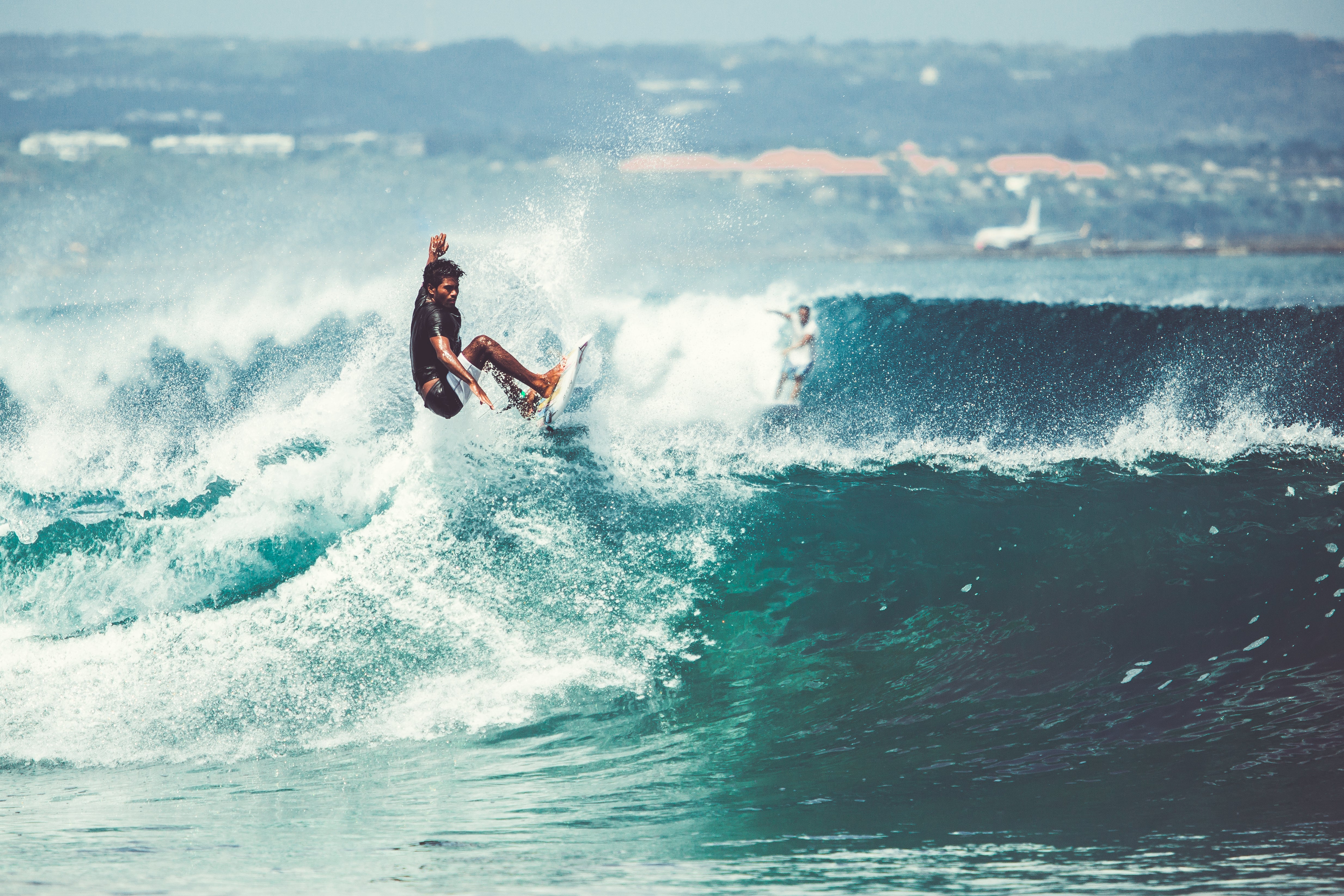 Surfista realizando manobra em uma onda grande, capturando a essência do surf no Brasil.