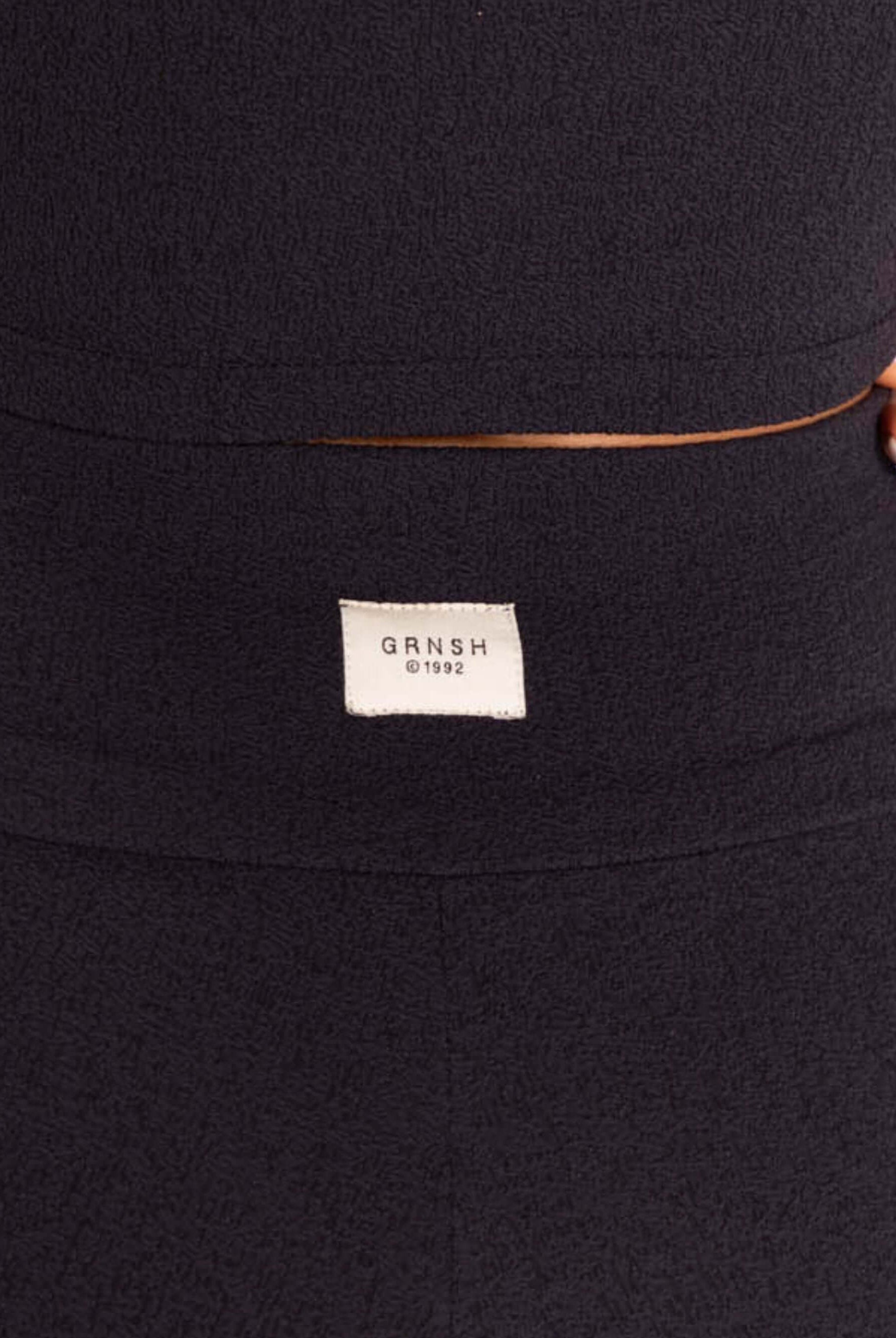 Etiqueta da marca Greenish em shorts fitness Aspetta - Preto, estilo e conforto para treinos.