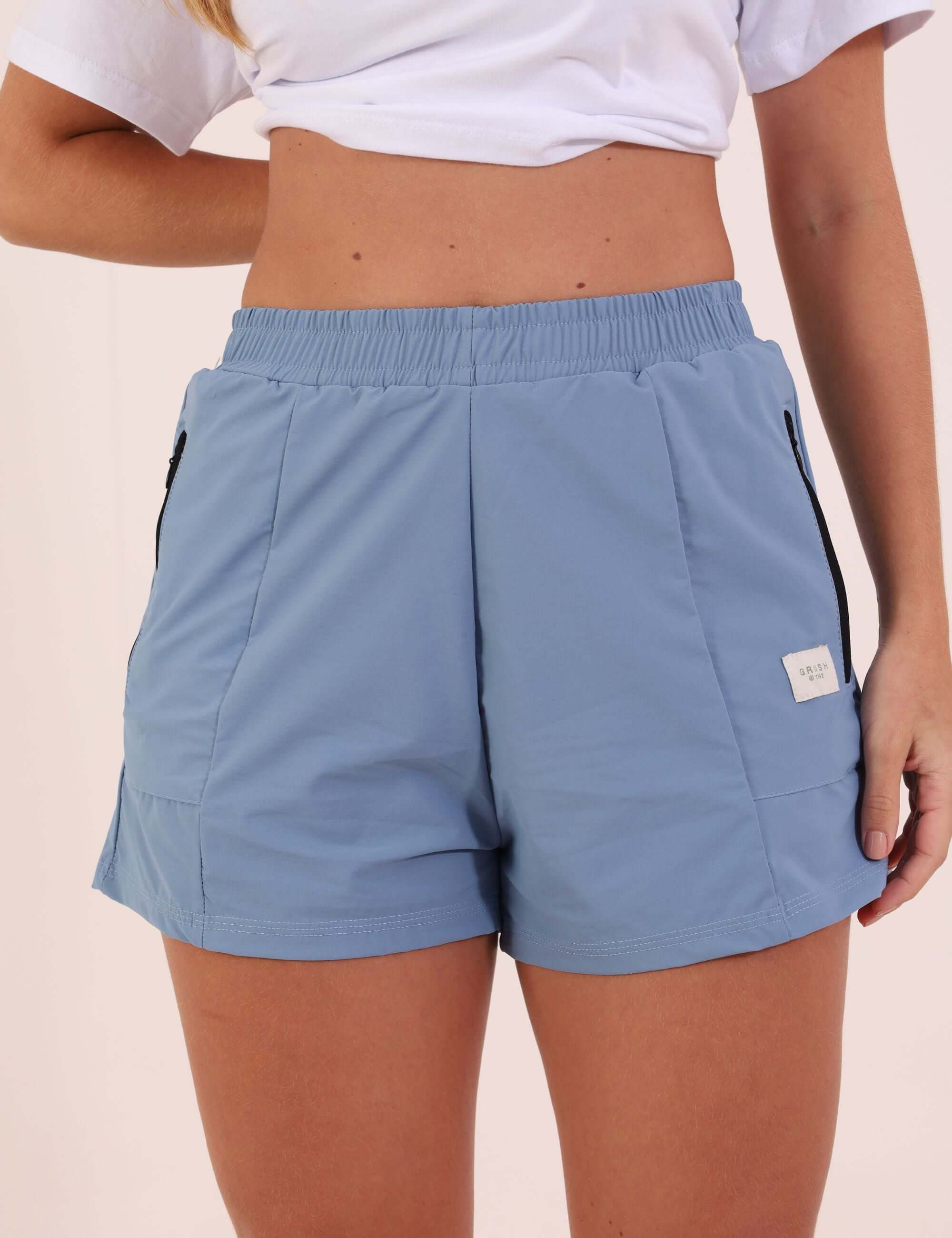 Short Sport New Track - Azul Indigo, lightweight quick-dry shorts made from performance mesh with elastic waistband and zip pocket.