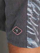 Detalhe da bermuda Boardwalk Erosion da Greenish com estampa lateral exclusiva e patch personalizado.