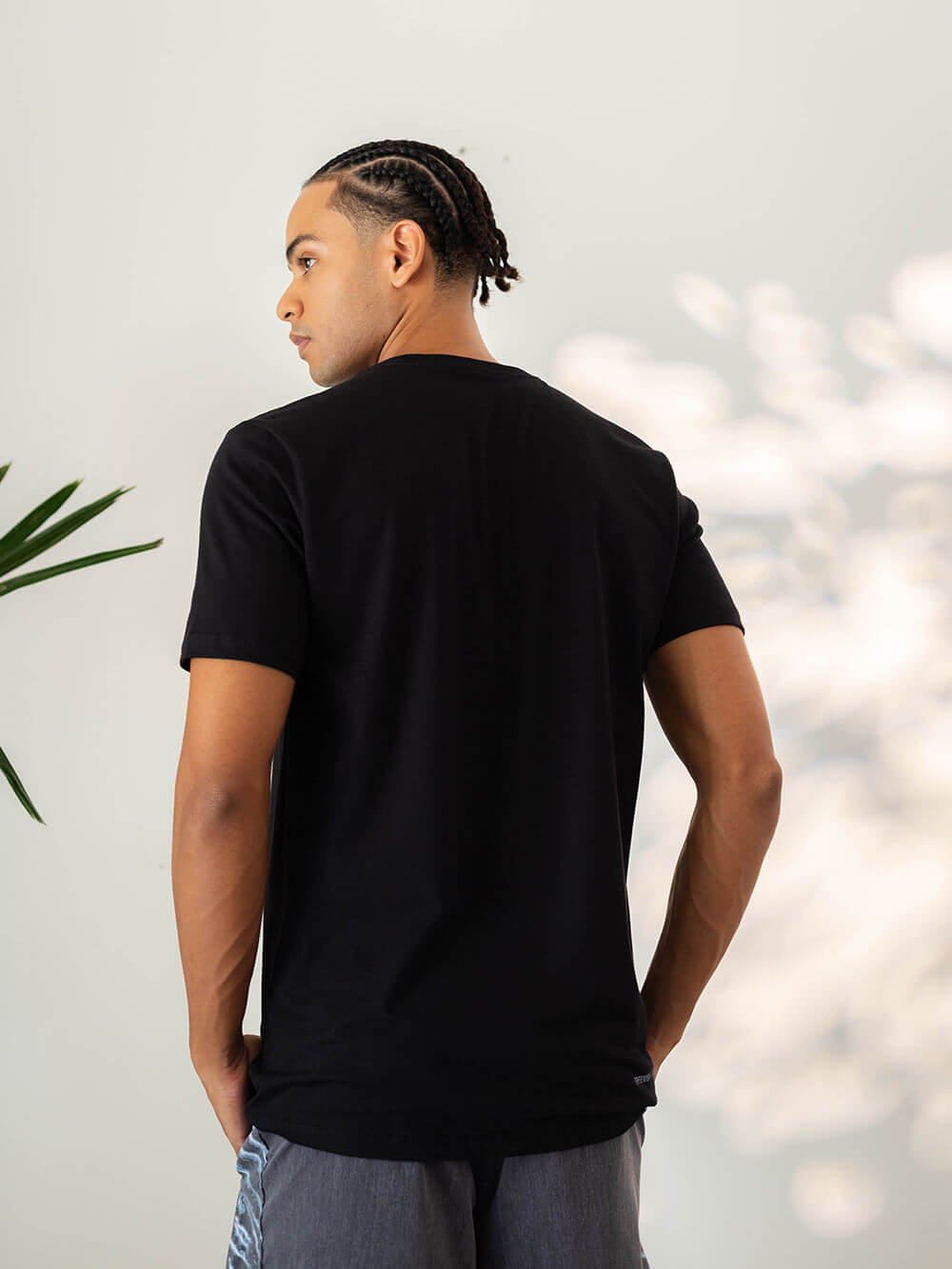 Camiseta Right Wave preta da Greenish, modelo masculino visto de costas, com um toque aconchegante e respirável.