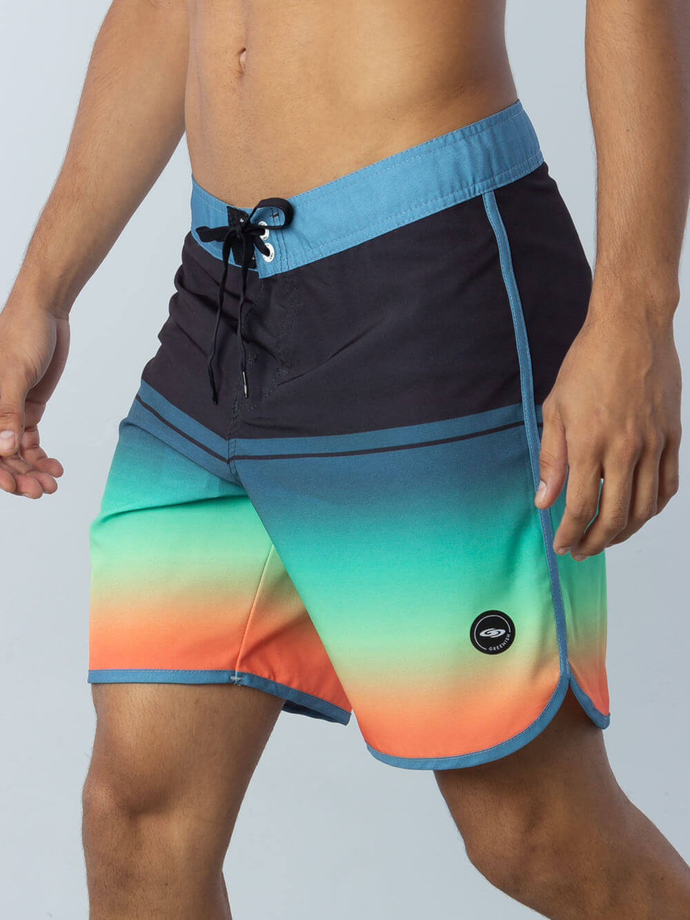 Greenish Boardsport Gradient Block shorts in black, green, and orange, perfect for beach days and water sports.