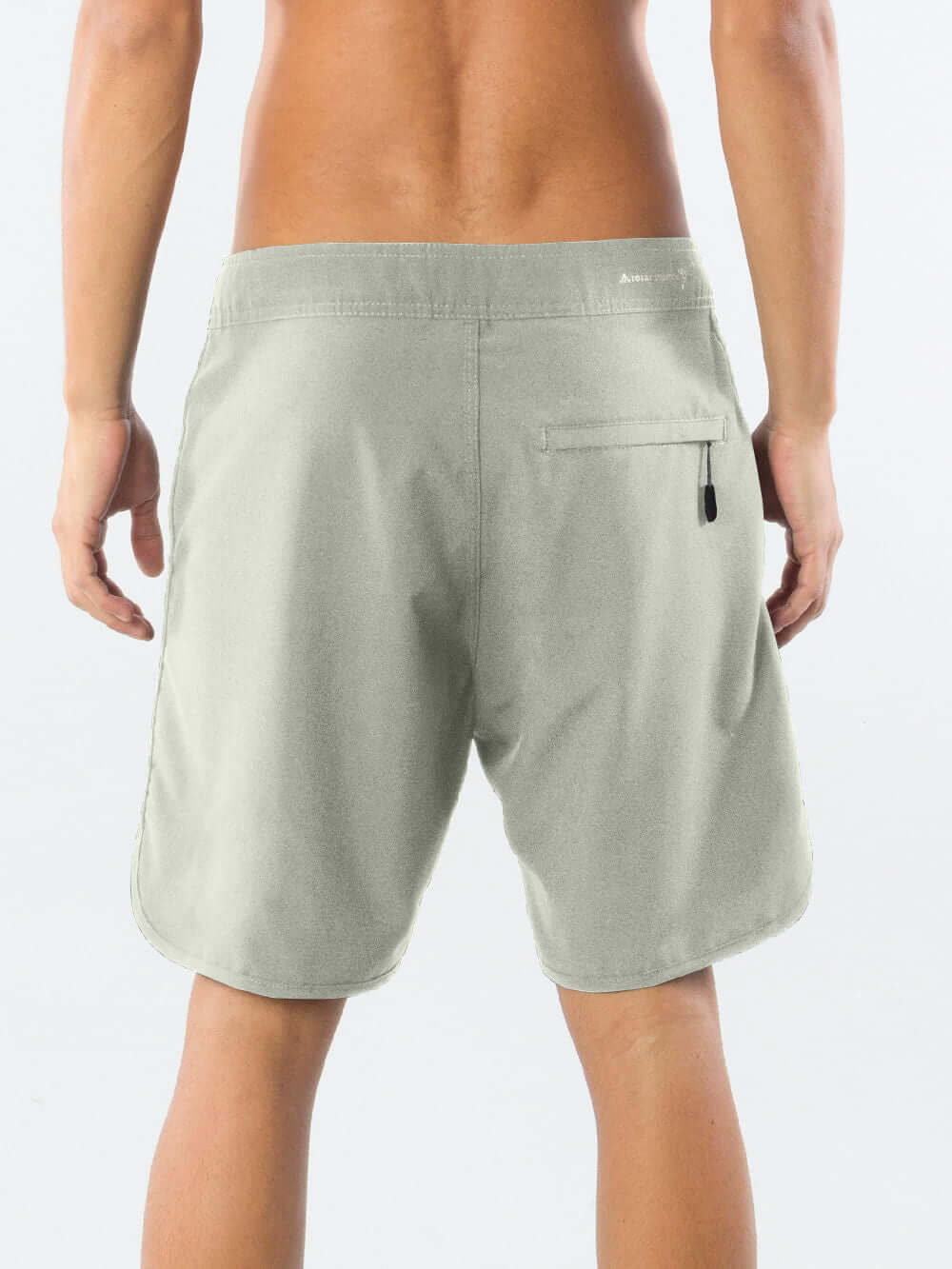 Boardwalk New Basic in beige by Greenish, showcasing the back with anatomical waist and stylish zipper pocket.