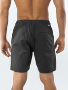 Man wearing Greenish Bermuda Basic Sarja shorts in gray, showcasing the back design and elastic waistband.