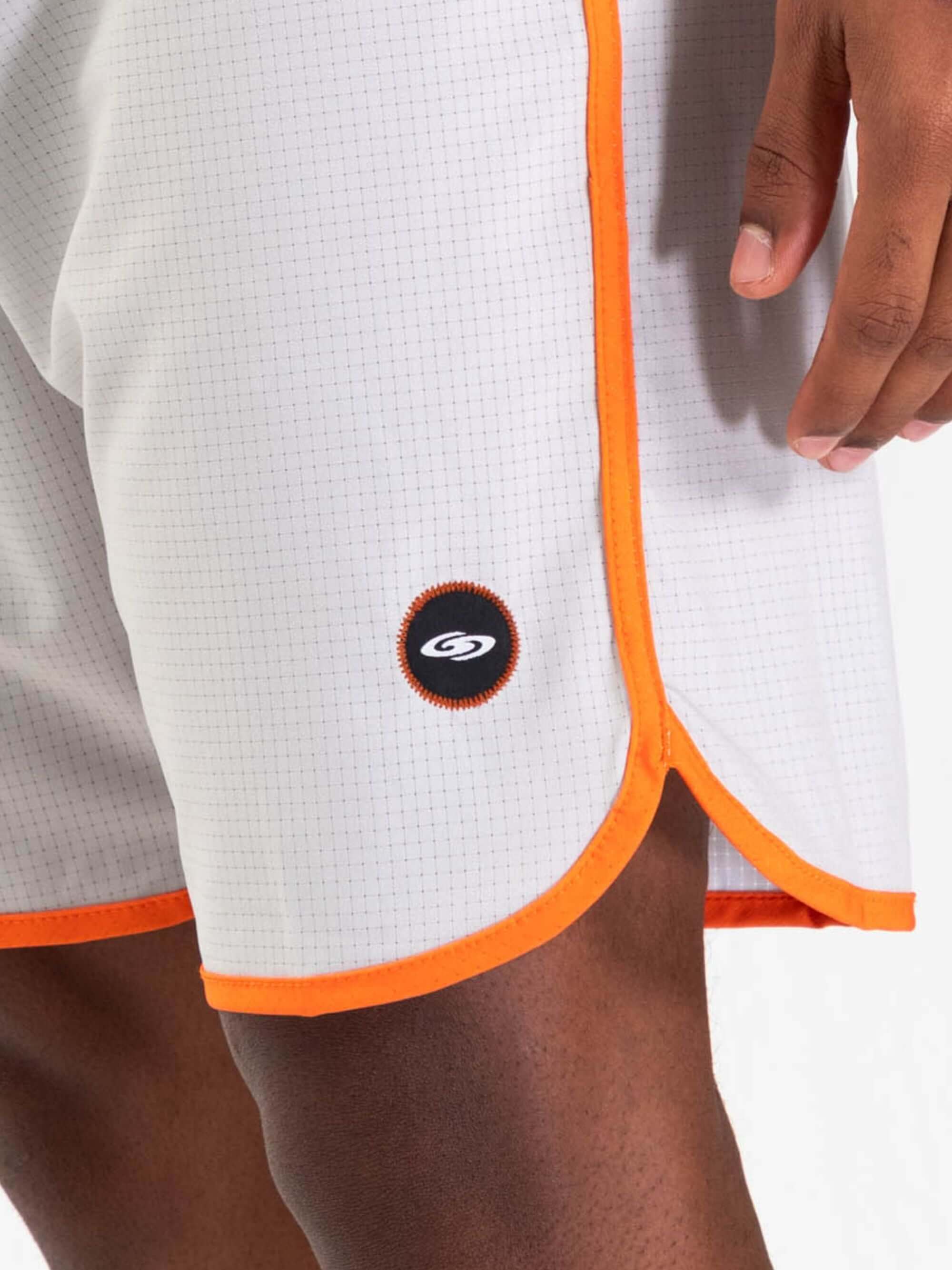 Detalhe da bermuda Retrô Flat Sea da Greenish, em tecido stretch com design moderno e detalhes laranja.