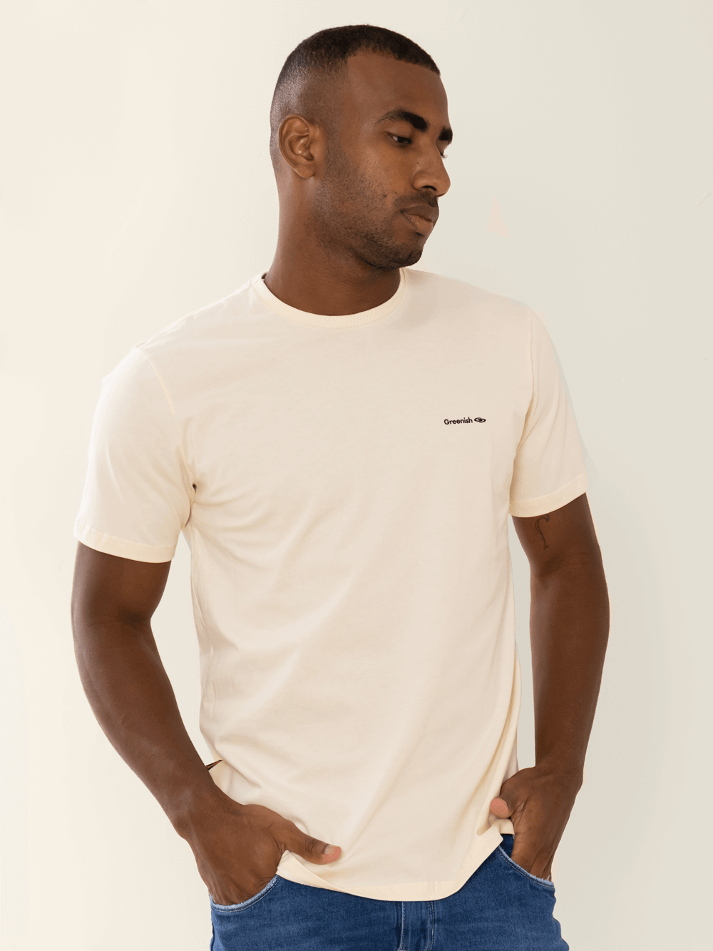 Camiseta beige minimalista com logo da Greenish, modelagem clássica, feita de algodão sustentável.