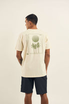 Camiseta Sunset Beach - Natural by Greenish, featuring a back graphic design with palm trees and sunset.