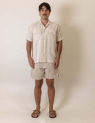 Greenish Camisa Botao Brisa - Natural worn by a model, showcasing the natural color and button detail in a casual setting.