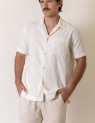 Camisa Botao High Tide - Off White by Greenish worn by a male model, showcasing its casual style and design.
