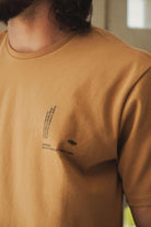 Camiseta Greenish Quality Product - Caqui com design minimalista e silk localizado, ideal para uso diário com conforto e estilo.