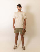 Modelo vestindo Camiseta Mermaid - Natural da marca Greenish em um fundo neutro