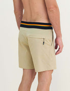 Man wearing Boardwalk Outline Backoutdoor - Areia shorts with vibrant striped waistband, perfect for casual outings.