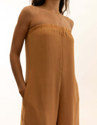Macacão Leslie - Caqui by Greenish. Elegant strapless jumpsuit in beige color. Perfect for fashion-forward individuals.