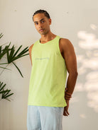 Modelo masculino usando a Regata Feel Alive Verde da Greenish, ideal para dias ensolarados e momentos descontraídos.