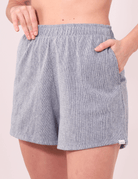 Modelo usando Short Salty Cinza da Greenish, com cintura alta, bolsos laterais e fenda na barra para conforto e estilo.
