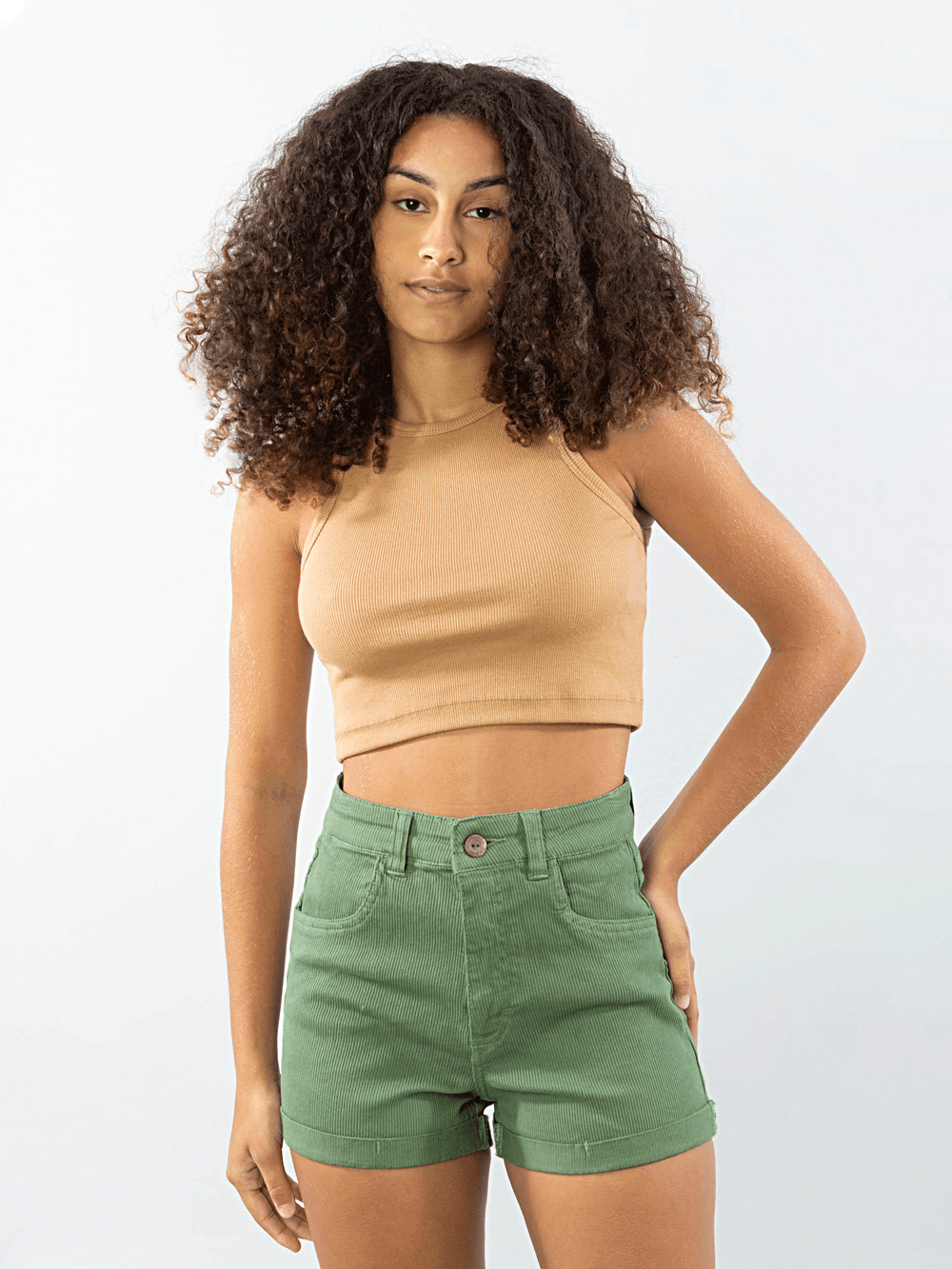 Modelo usando shorts vintage verde da marca Greenish, apresentando um estilo casual e moderno.
